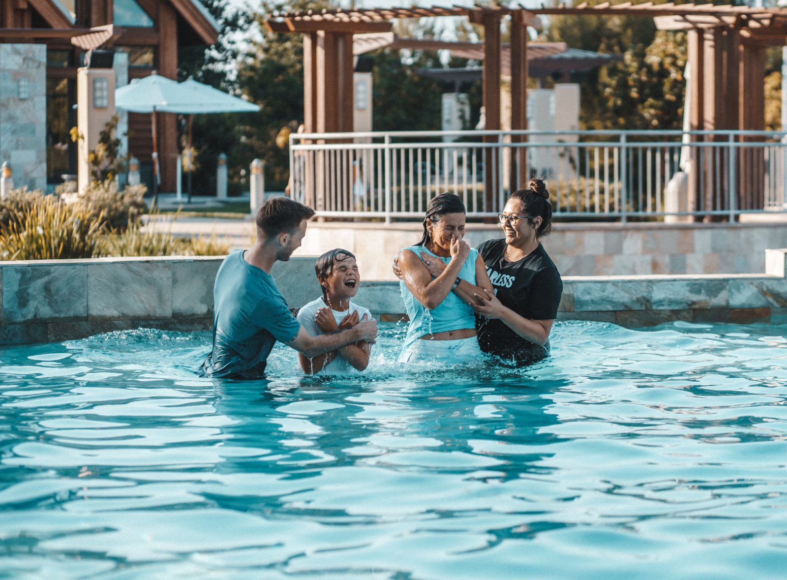 A kid and young adult being baptized