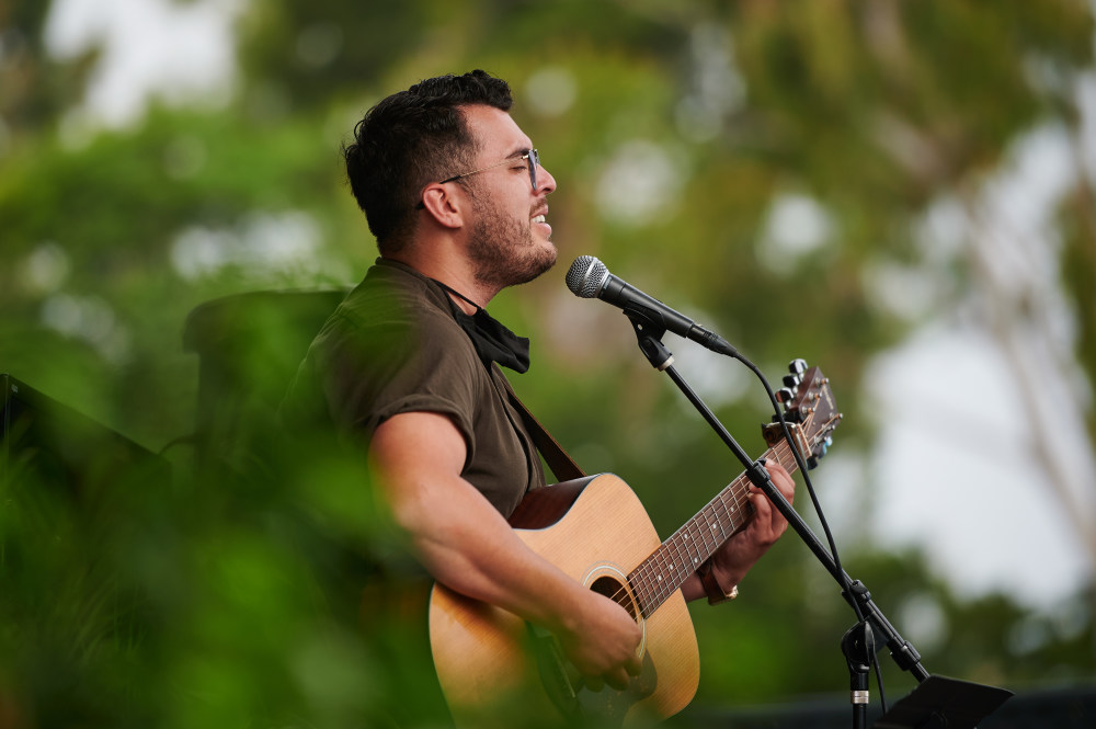 Person singing and playing guitar