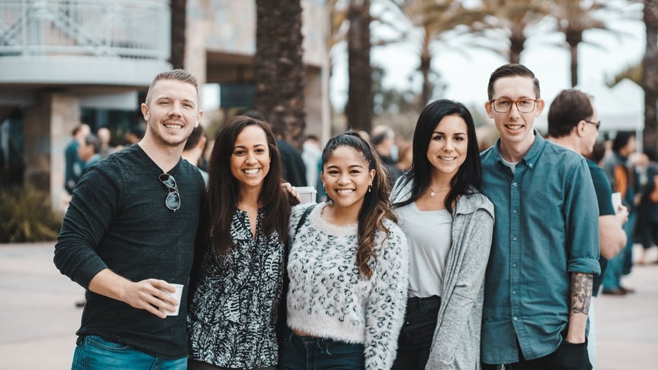 A group of people gathering and smiling