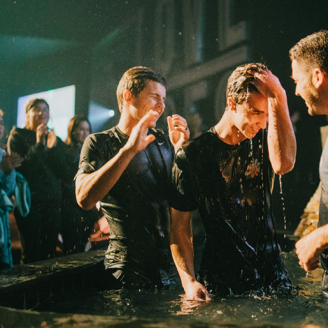 Young adults being baptized